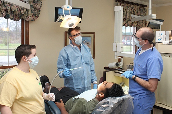 Dentist and team members treating patient