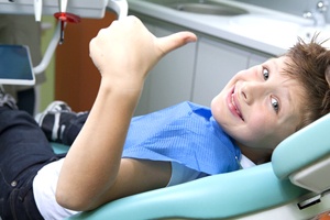 Smiling child in dentist’s chair
