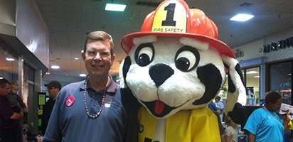 Dentist and fire dog mascot at community event